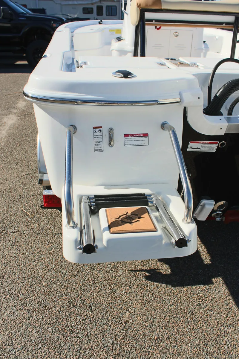 Slide: The Image of 2025 NauticStar 214 Shallow Bay boat with rear swim platform and ladder. - 11