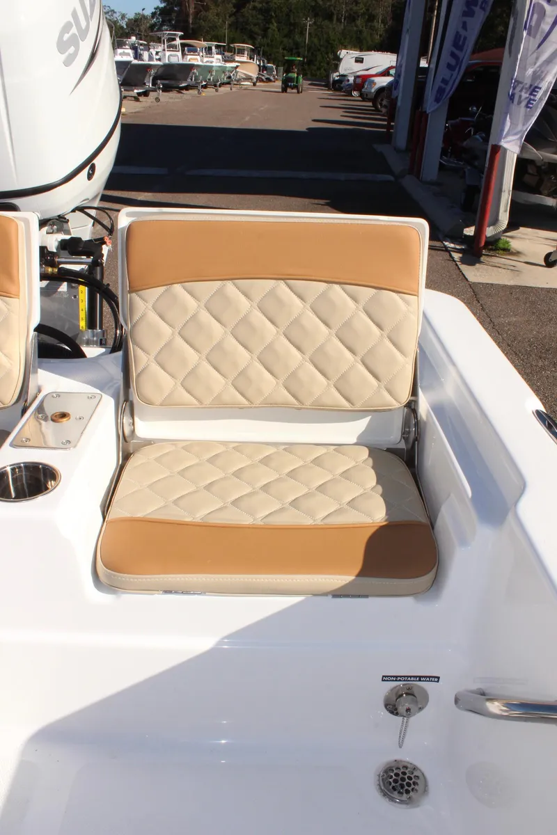 Slide: The Image of 2025 NauticStar 214 Shallow Bay boat seat with tan and white diamond pattern upholstery. - 13
