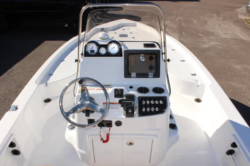 Slide: The Image of 2025 NauticStar 214 Shallow Bay boat dashboard with steering wheel and gauges. - 14