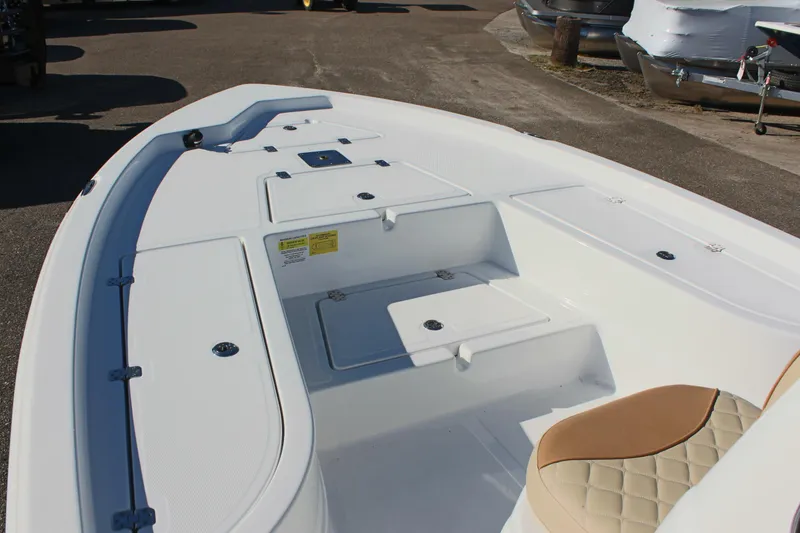 Slide: The Image of 2025 NauticStar 214 Shallow Bay boat interior with storage compartments and seating. - 19