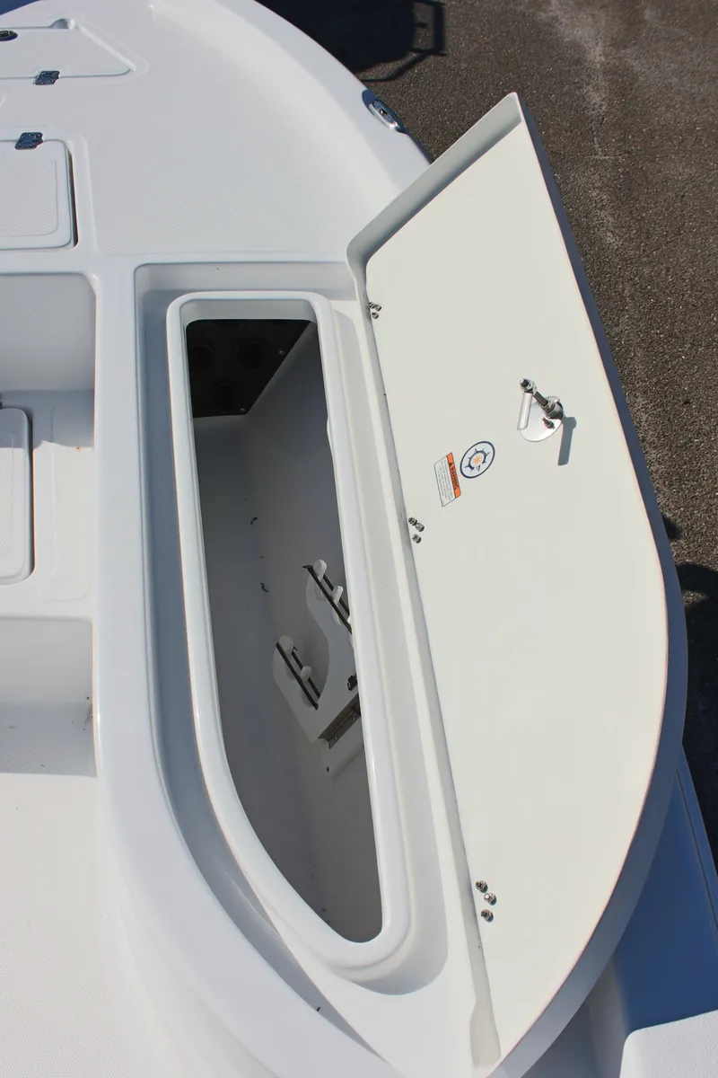 Slide: The Image of 2025 NauticStar 214 Shallow Bay boat storage compartment open on deck. - 21