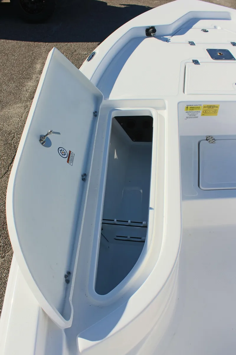 Slide: The Image of 2025 NauticStar 214 Shallow Bay boat storage compartment open on deck. - 22
