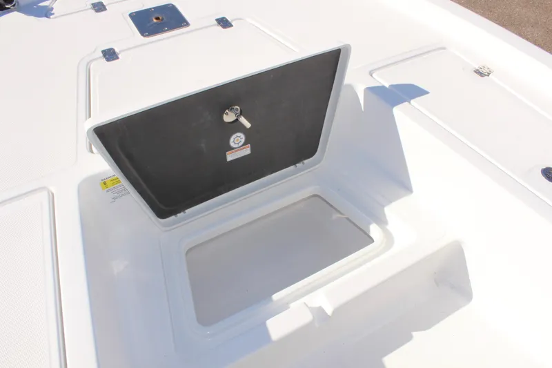Slide: The Image of 2025 NauticStar 214 Shallow Bay boat storage compartment open on deck. - 23