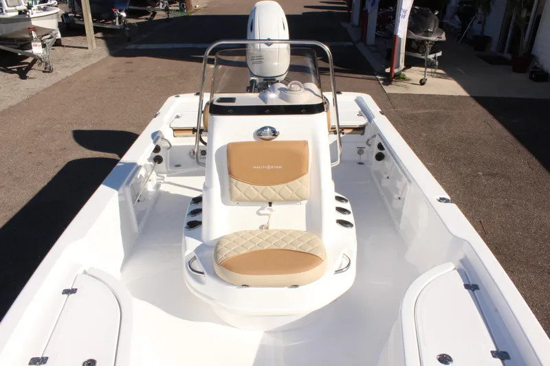 Slide: The Image of 2025 NauticStar 214 Shallow Bay boat with tan seating, ideal for shallow water adventures. - 26