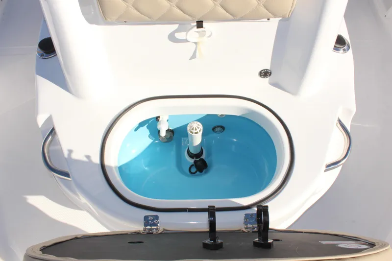 Slide: The Image of 2025 NauticStar 214 Shallow Bay boat livewell with blue interior. - 28