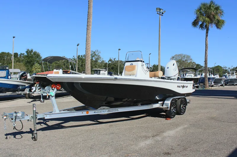 Slide: The Image of 2025 NauticStar 214 Shallow Bay boat on trailer in sunny parking lot. - 3