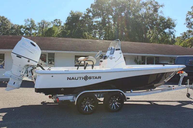 Slide: The Image of 2025 NauticStar 214 Shallow Bay boat on trailer, parked outdoors. - 7