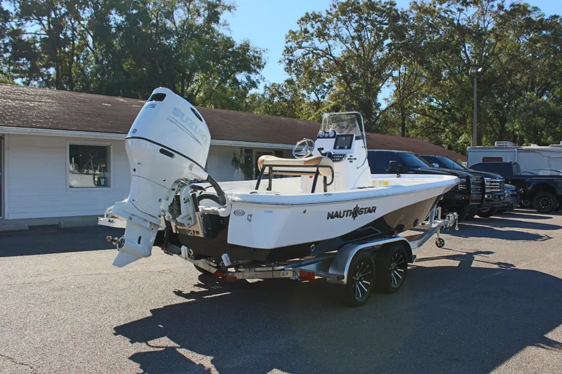 Slide: The Image of 2025 NauticStar 214 Shallow Bay boat on trailer, parked outdoors. - 8