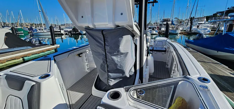 Slide: The Image of 2023 Yamaha Boats 255 FSH Sport E at marina, showcasing spacious deck and sleek design. - 25