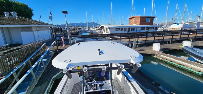 Slide: The Image of 2023 Yamaha Boats 255 FSH Sport E docked at marina with clear blue sky. - 9