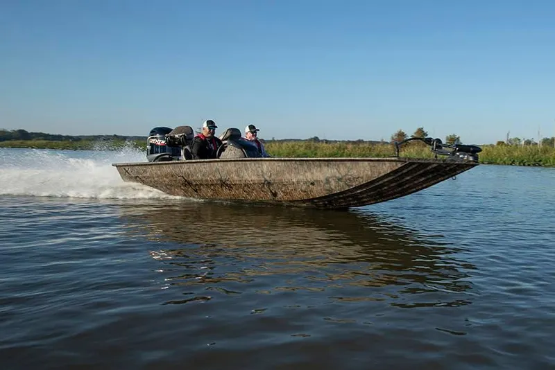 Slide: The Image of 2025 Xpress XP200 Catfish boat speeding on a lake with passengers. - 1
