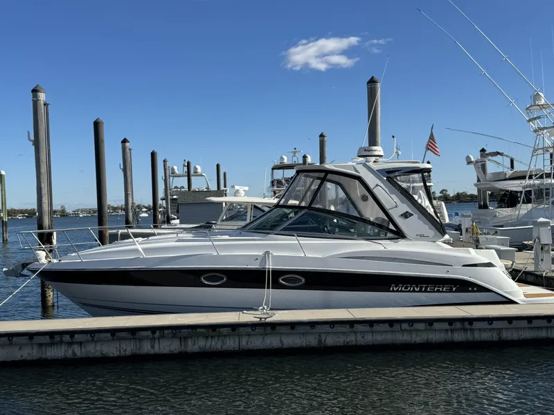 Slide: The Image of 2018 Monterey 335 SY boat docked at marina under clear blue sky. - 1