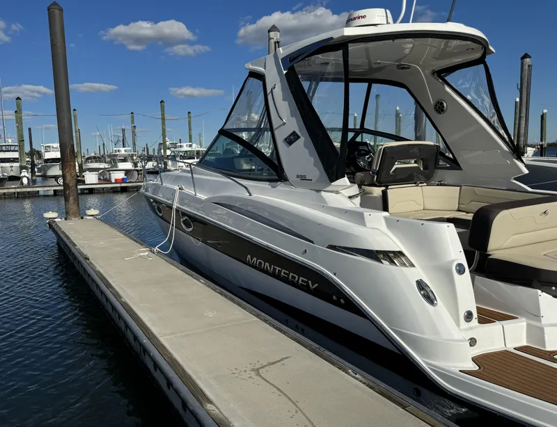 Slide: The Image of 2018 Monterey 335 SY boat docked at marina under blue sky. - 2