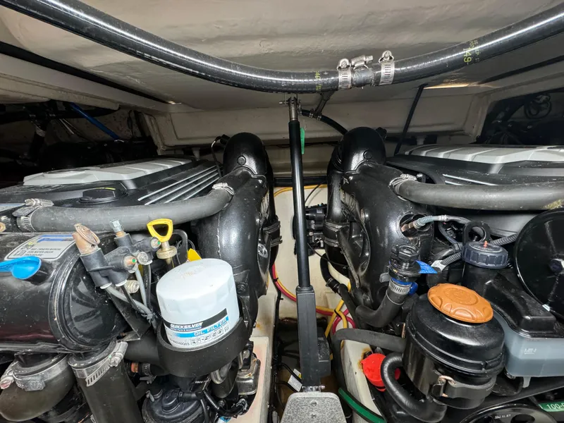 Slide: The Image of Engine compartment of a 2018 Monterey 335 SY boat, showcasing dual engines and components. - 27