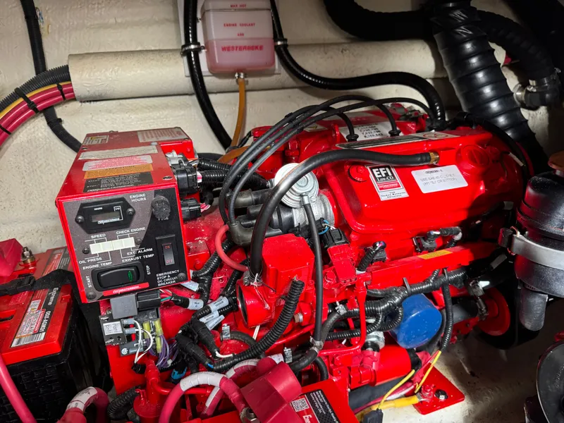 Slide: The Image of Engine compartment of a 2018 Monterey 335 SY boat, featuring red EFI engine components. - 28