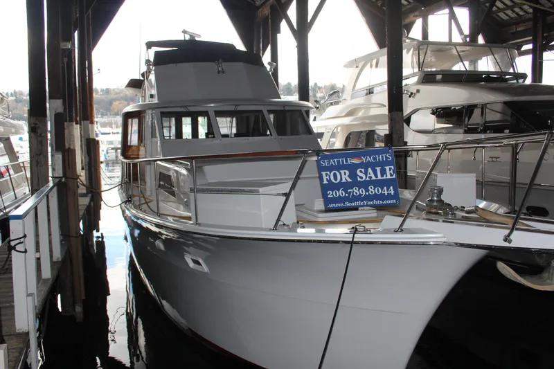 The Image of 1974 Hatteras 58 Yachtfish for sale at marina, Seattle Yachts sign visible. - 0