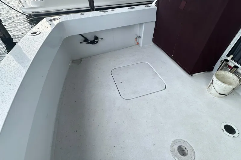 Slide: The Image of 1974 Hatteras 58 Yachtfish deck with storage hatch and fishing rod holder. - 1