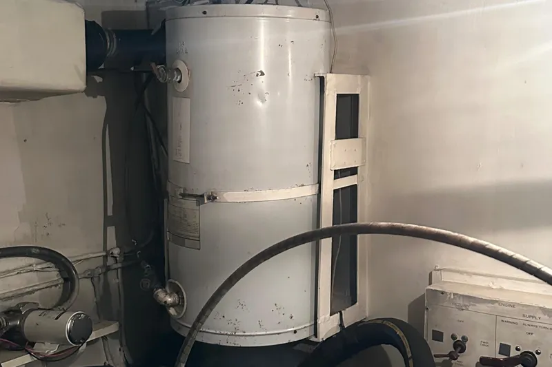 Slide: The Image of Engine room of 1974 Hatteras 58 Yachtfish with water heater and equipment. - 10