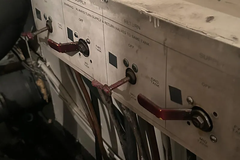 Slide: The Image of Control panel of a 1974 Hatteras 58 Yachtfish with levers and switches. - 11