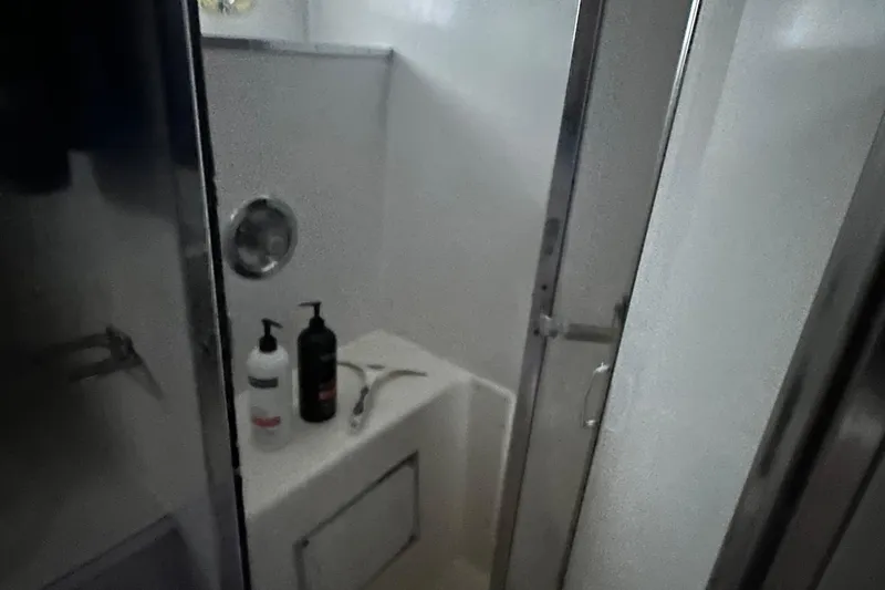 Slide: The Image of 1974 Hatteras 58 Yachtfish bathroom with shower and toiletries. - 13