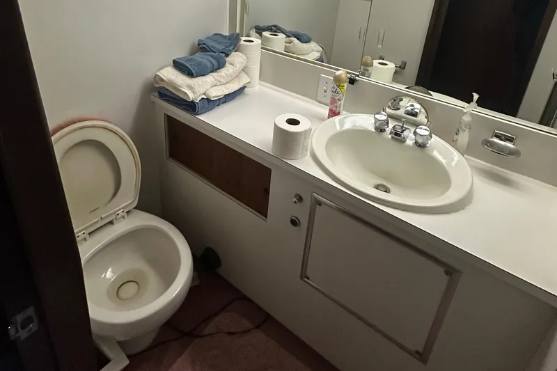 Slide: The Image of Bathroom interior of 1974 Hatteras 58 Yachtfish with sink and toilet. - 14