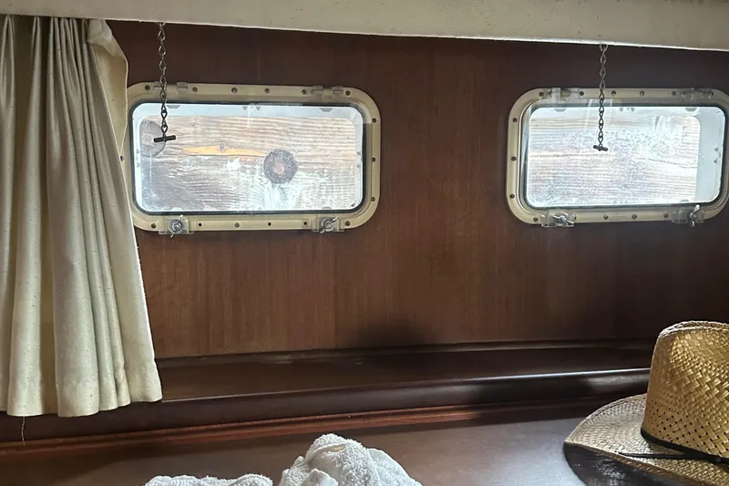 Slide: The Image of Interior of 1974 Hatteras 58 Yachtfish with portholes and curtains. - 18
