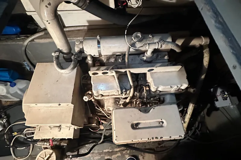 Slide: The Image of Engine room of a 1974 Hatteras 58 Yachtfish, showcasing mechanical components. - 22