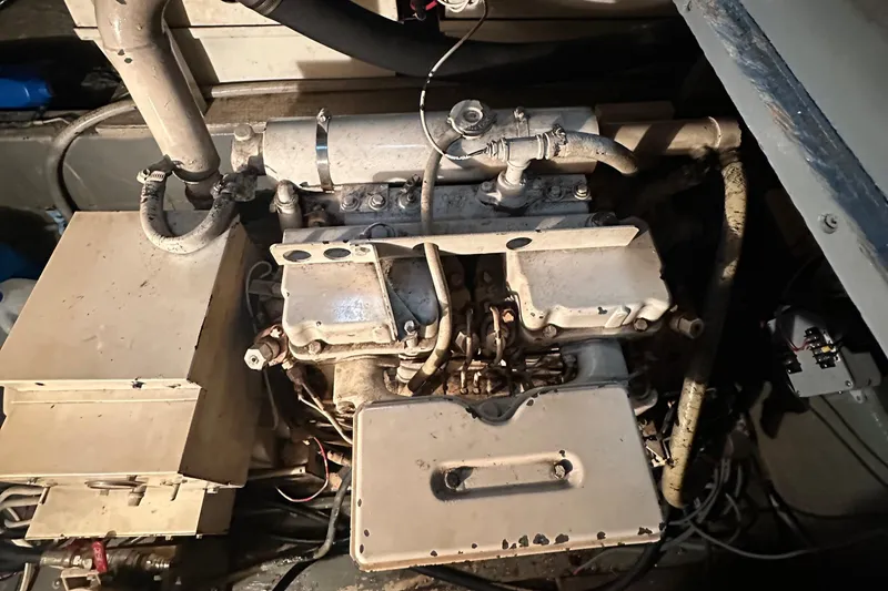 Slide: The Image of Engine room of a 1974 Hatteras 58 Yachtfish, showcasing mechanical components. - 25