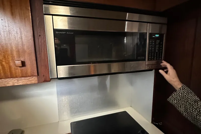 Slide: The Image of Microwave in 1974 Hatteras 58 Yachtfish kitchen, with wooden cabinets and modern design. - 28