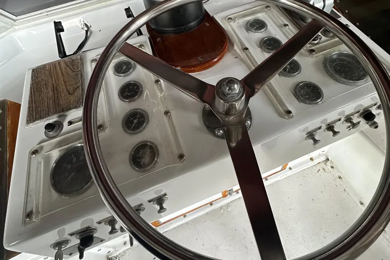 Slide: The Image of 1974 Hatteras 58 Yachtfish helm with vintage steering wheel and instrument panel. - 29
