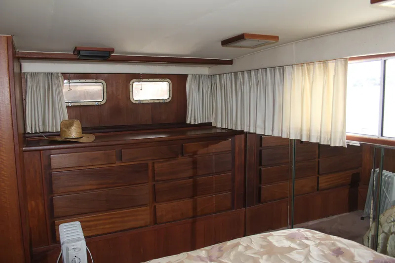 Slide: The Image of Interior of 1974 Hatteras 58 Yachtfish with wooden cabinetry and curtains. - 33