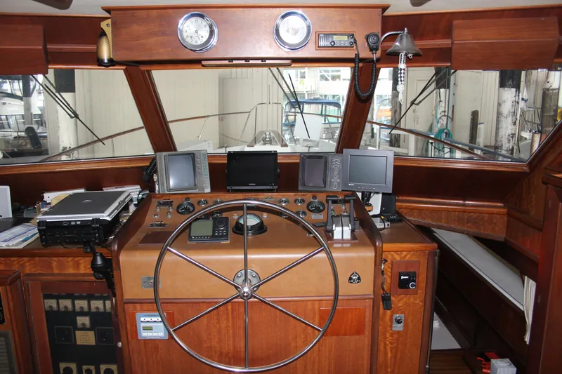 Slide: The Image of 1974 Hatteras 58 Yachtfish helm with wooden dashboard and navigation equipment. - 42