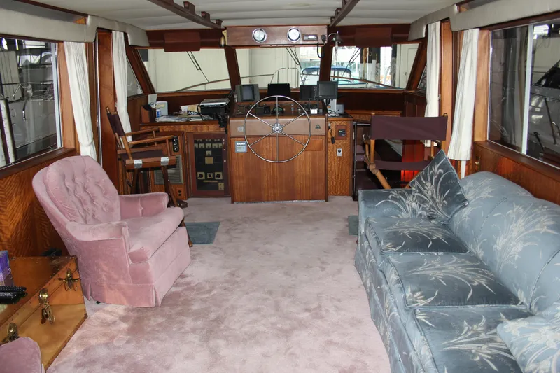 Slide: The Image of Interior of 1974 Hatteras 58 Yachtfish with plush seating and classic wooden helm. - 43