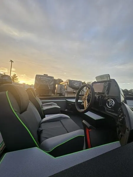 Slide: The Image of 2025 Xpress H20C Crappie boat interior at sunset, featuring modern seating and dashboard. - 10