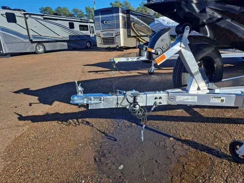 Slide: The Image of Trailer hitch of 2025 Xpress H20C Crappie boat in parking lot with RVs. - 2