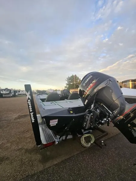 Slide: The Image of 2025 Xpress H20C Crappie boat with Yamaha outboard motor under a cloudy sky. - 4