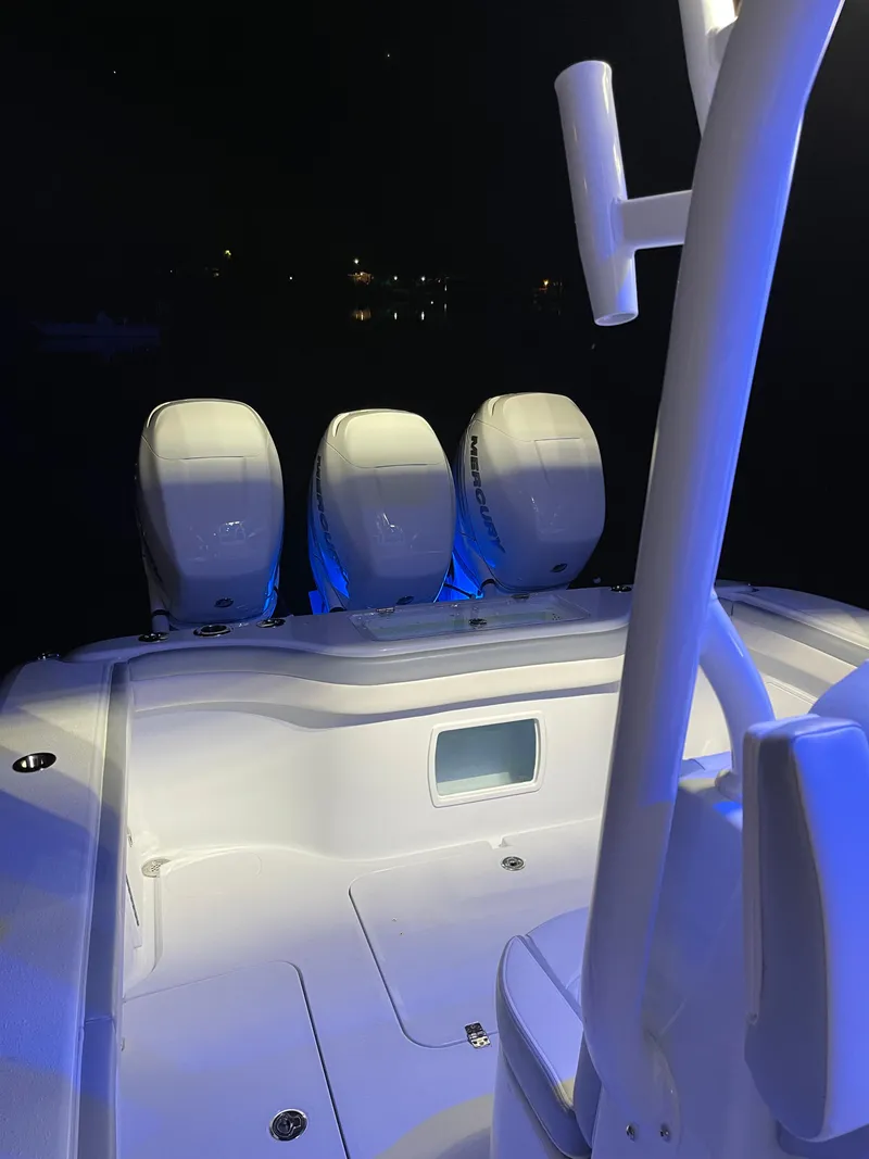 Slide: The Image of 2022 Yellowfin 34 boat with triple engines, illuminated at night. - 44