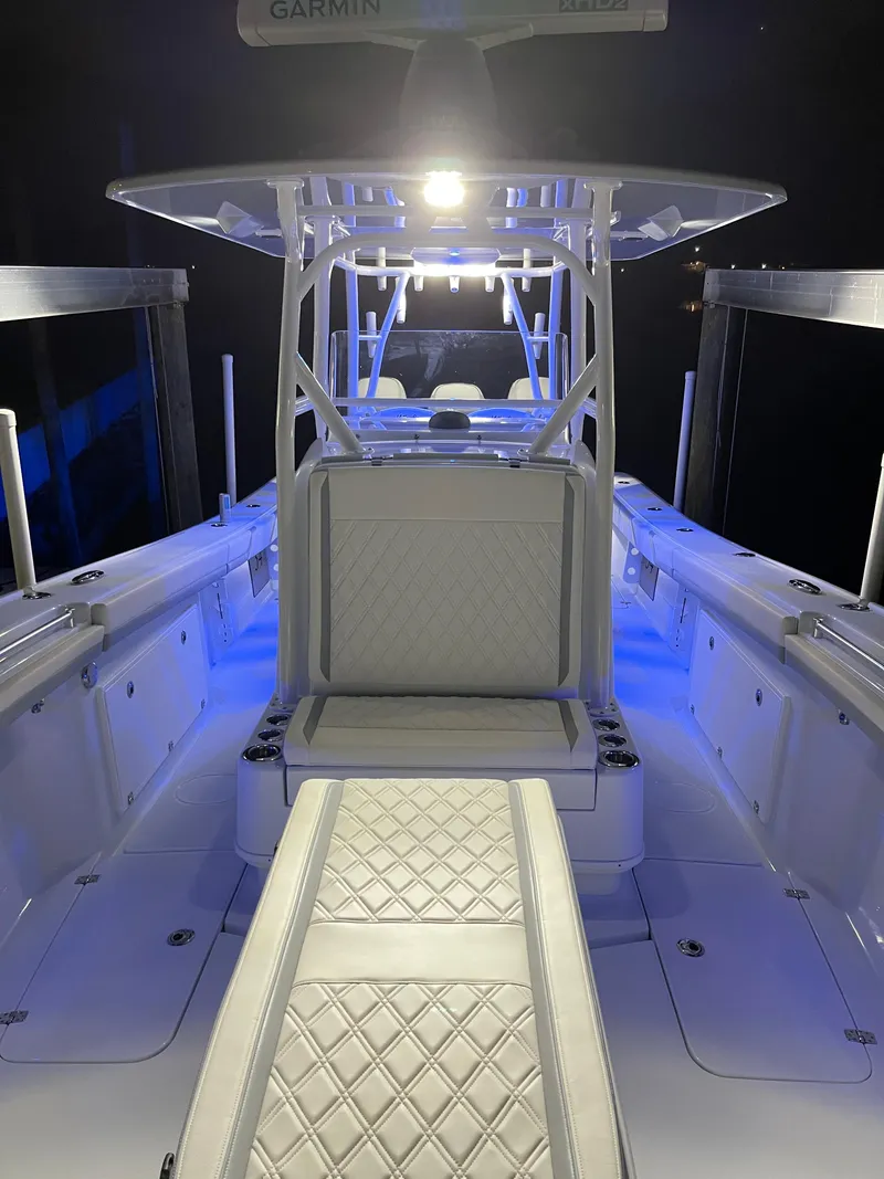 Slide: The Image of 2022 Yellowfin 34 boat interior with blue LED lighting and cushioned seating. - 46
