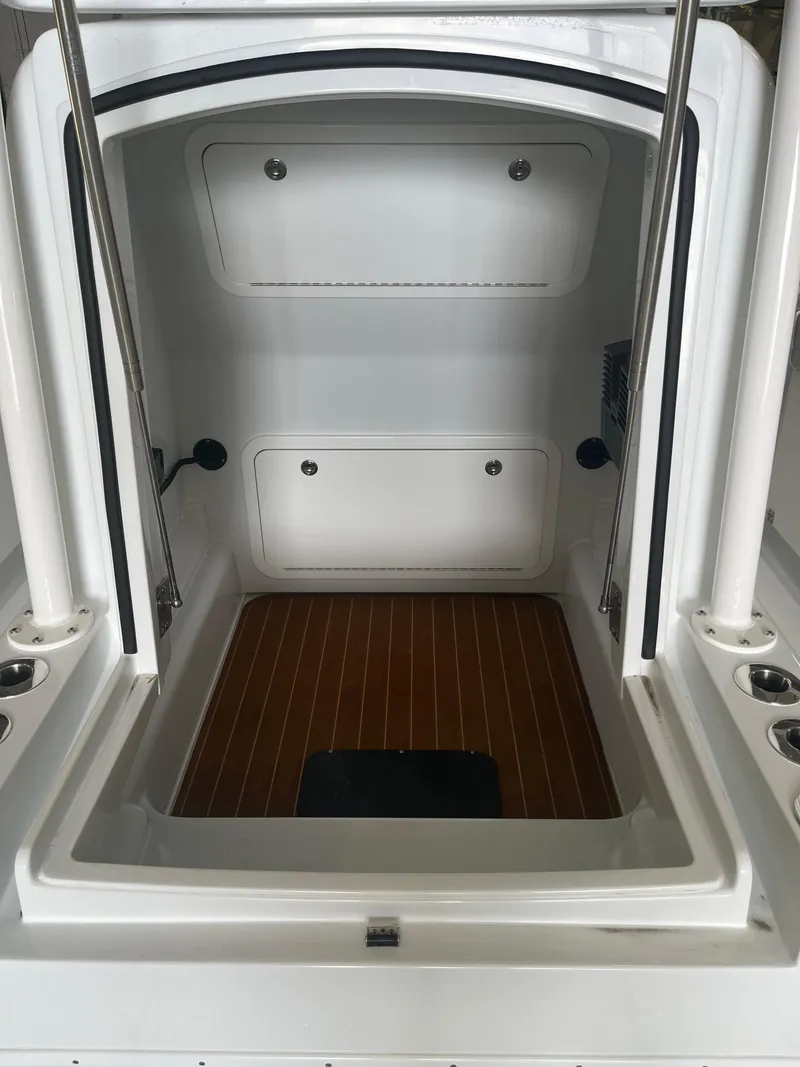 Slide: The Image of 2022 Yellowfin 34 boat cabin interior with wood flooring and storage compartments. - 47