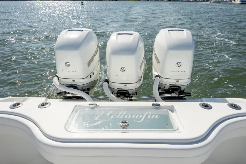 Slide: The Image of 2022 Yellowfin 34 boat with triple outboard engines on the water. - 8