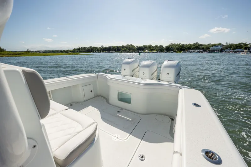 Slide: The Image of 2022 Yellowfin 34 boat with triple engines on a sunny day. - 9