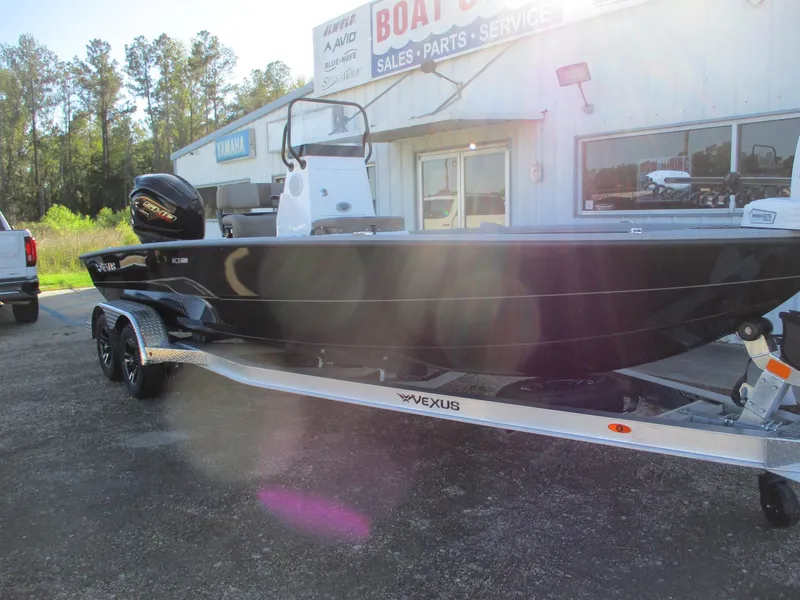 Slide: The Image of 2025 Vexus ACX 2210 boat on trailer outside dealership. - 1