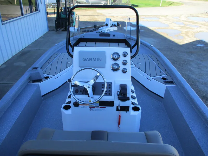 Slide: The Image of 2025 Vexus ACX 2210 boat interior with Garmin dashboard and steering wheel. - 12