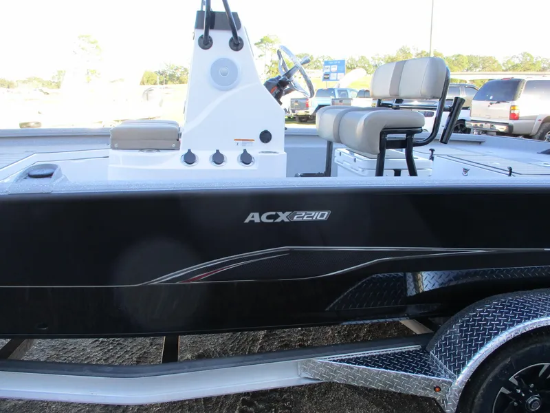 Slide: The Image of 2025 Vexus ACX 2210 boat, side view, black exterior, dual seating, on trailer. - 5