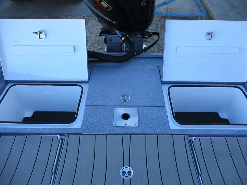 Slide: The Image of 2025 Vexus ACX 2210 boat deck with open storage compartments and motor. - 9