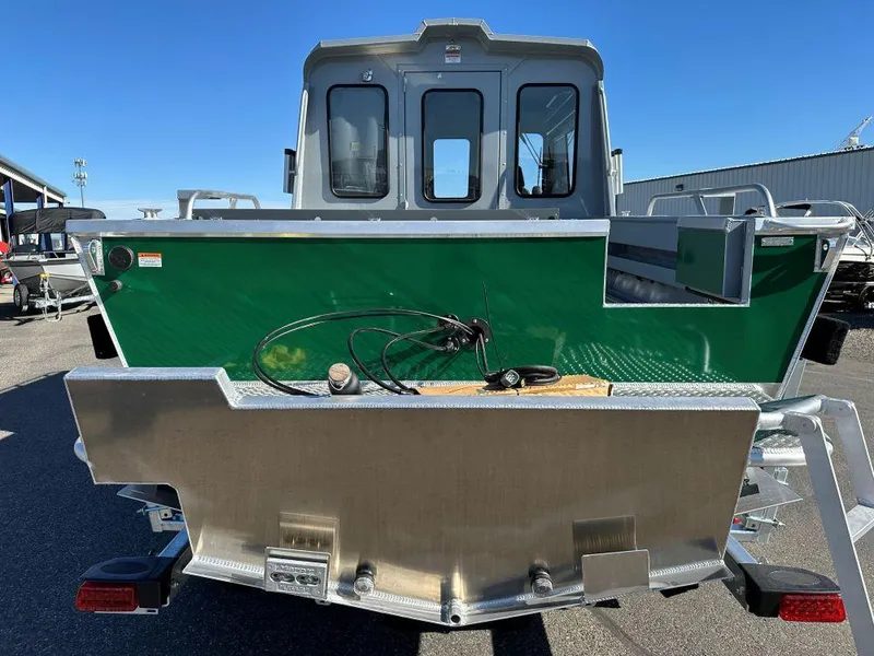 Slide: The Image of 2025 Hewescraft 220 Ocean Pro ET HT boat, green exterior, rear view in a parking lot. - 3