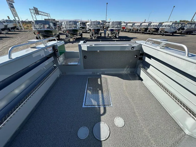 Slide: The Image of 2025 Hewescraft 220 Ocean Pro ET HT boat interior, spacious deck, and storage compartments. - 9