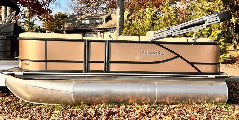 Slide: The Image of 2025 Bentley Pontoons LE 160CR pontoon boat on autumn leaves. - 0