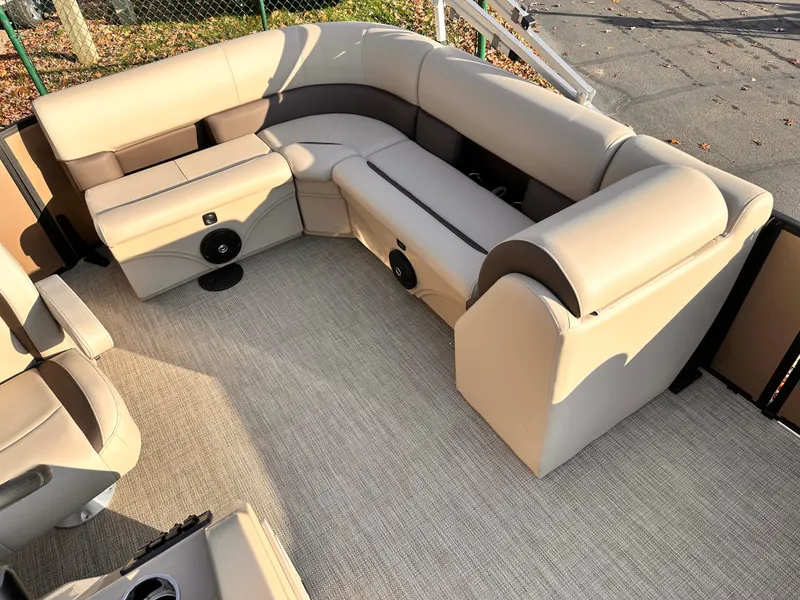 Slide: The Image of 2025 Bentley Pontoons LE 160CR interior with beige seating and carpet flooring. - 11