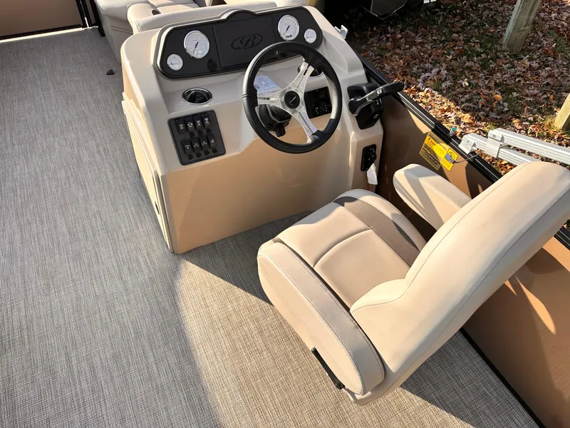Slide: The Image of 2025 Bentley Pontoons LE 160CR interior with steering wheel and dashboard controls. - 12